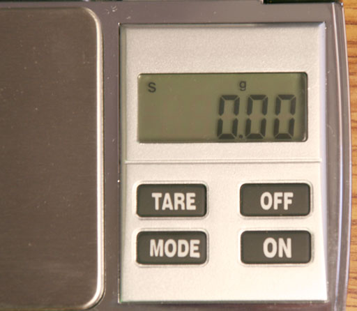 LCD display on digital balance showing g for grams