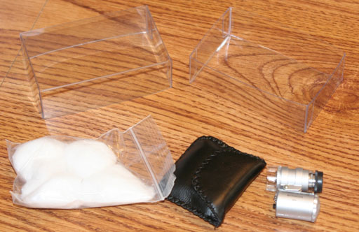 plastic case, microscope, and cotton balls