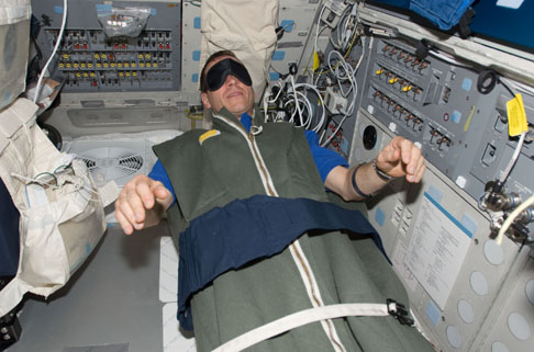 astronaut sleeping in space