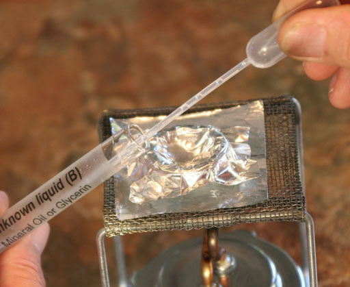 mineral oil being transferred to aluminum crucible with a pipette