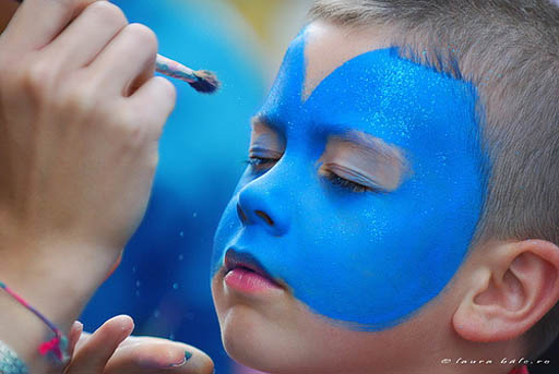Face painting on boys face with blue paint